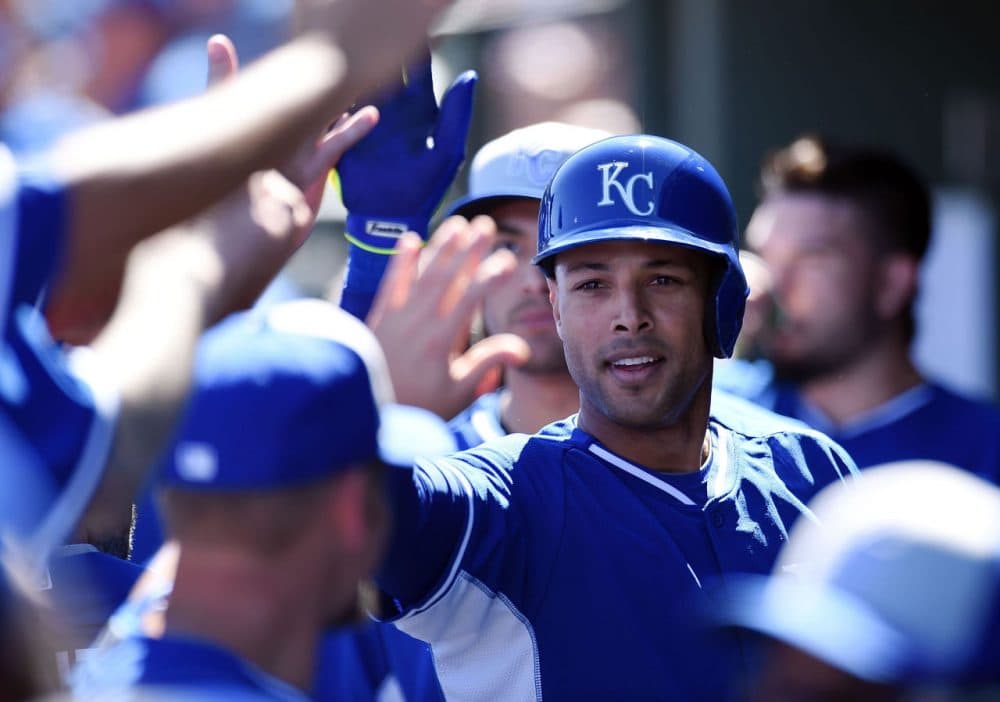 Alex Rios #15 of the Kansas City Royals celebrates with teammates after hitting a first inning home run against the Texas Rangers on March 4, 2015 in Surprise, Arizona. (Norm Hall/Getty Images)