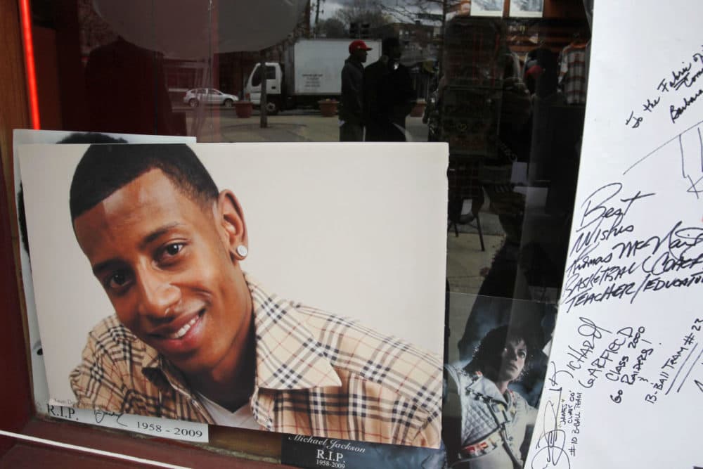 A photograph of college football player Danroy Henry Jr., who was shot and killed by a police officer, is seen in the window of a radio station, in Boston's Roxbury neighborhood in April 2011. (Steven Senne/AP)