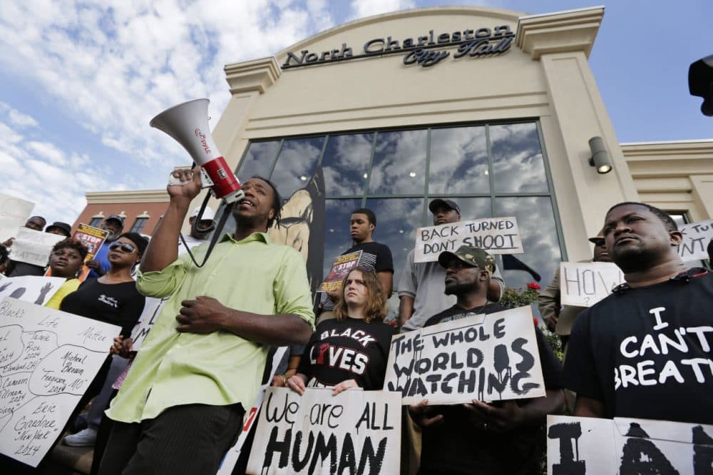 Muhiydin D'Baha leads a group protesting the shooting death of Walter Scott at city hall in North Charleston, S.C., Wednesday, April 8, 2015. Scott was killed by a North Charleston police office after a traffic stop on Saturday. The officer, Michael Thomas Slager, has been charged with murder. (Chuck Burto/AP)