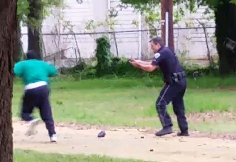 In this frame from video provided by Attorney L. Chris Stewart, representing the family of Walter Lamer Scott, Scott appears to be running away from City Patrolman Michael Thomas Slager, right, in North Charleston, S.C. Slager was charged with murder on Tuesday, April 7, hours after law enforcement officials viewed the dramatic video that appears to show him shooting a fleeing Scott several times in the back. (Courtesy of L. Chris Stewart via AP)