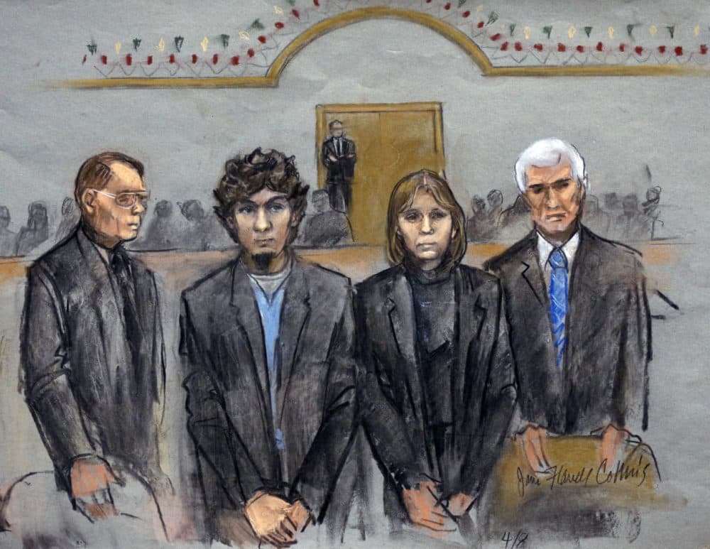 In this courtroom sketch, Dzhokhar Tsarnaev, second from left, is depicted standing with his defense attorneys William Fick, left, Judy Clarke, second from right, and David Bruck, right, as the jury presents its verdict in his federal death penalty trial. The jury found Tsarnaev guilty. (Jane Flavell Collins/AP)