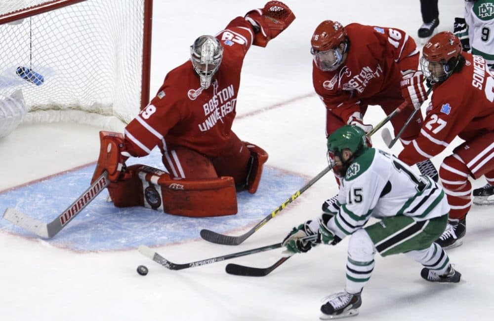 North Dakota forward Michael Parks (15) has his shot stopped by Boston University goalie Matt O'Connor during the second period of a semifinal at the NCAA men's Frozen Four hockey tournament in Boston Thursday. (Charles Krupa/AP)