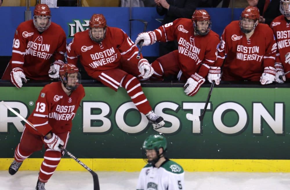 Boston University players leap over the boards after a win against North Dakota in a semifinal at the NCAA men's Frozen Four hockey tournament in Boston, Thursday, April 9, 2015. BU defeated North Dakota 5-3 and will play Providence in the championship game. (Charles Krupa/AP)
