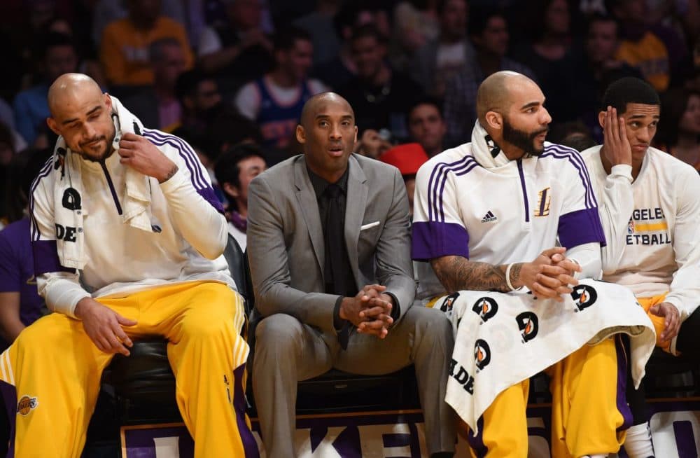 Injuries have kept some Lakers players -- like star Kobe Bryant (in suit) -- off the floor. Others are sitting for more suspicious reasons... (Mark Ralston/AFP/Getty Images)