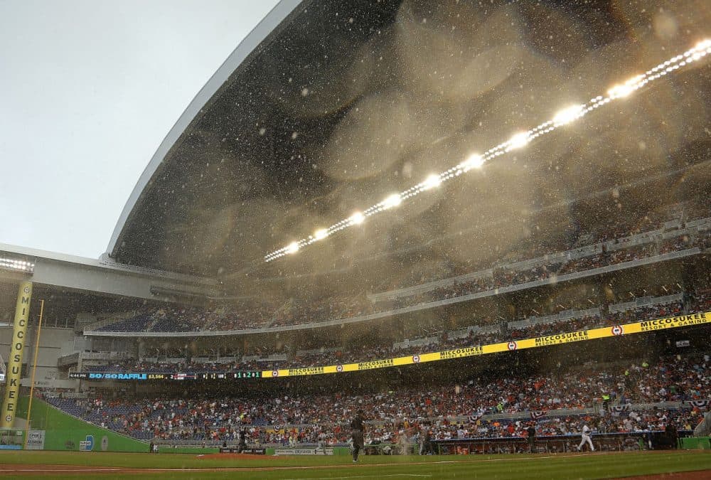 The Miami marlins' retractable roof took 16 minutes to close after an unexpected downpour of rain on Opening Day.  (Mike Ehrmann/Getty Images)