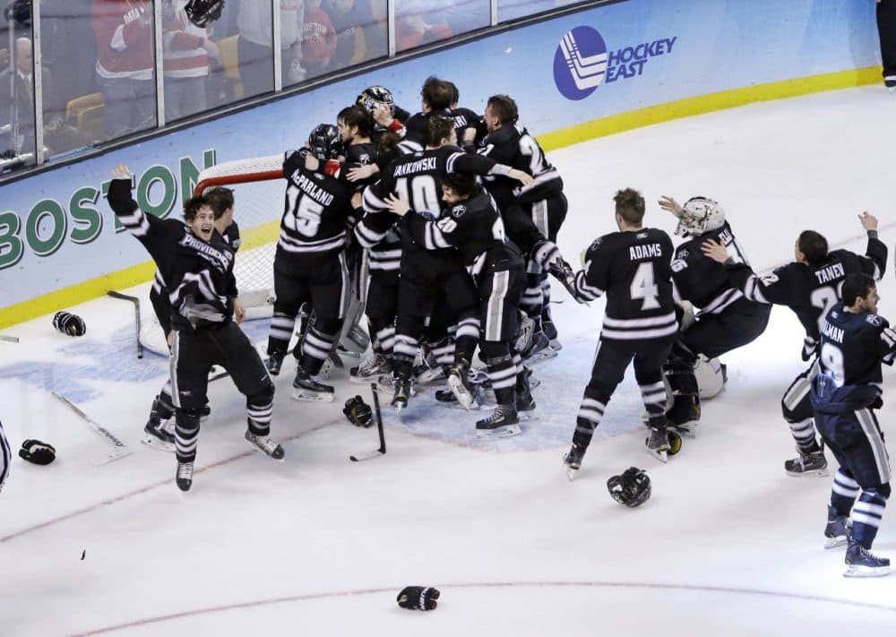 Providence players celebrate their 4-3 victory over Boston University in the NCAA men's Frozen Four hockey championship game in Boston, Saturday, April 11, 2015. (Elise Amendola/AP)