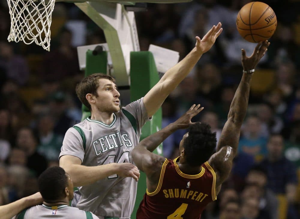 Boston Celtics center Tyler Zeller, left, reaches to block a shot by Cleveland Cavaliers guard Iman Shumpert. (Steven Senne/AP)