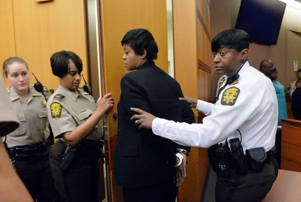 Former Deerwood Academy assistant principal Tabeeka Jordan, center, is led to a holding cell after a jury found her guilty in the Atlanta Public Schools test-cheating trial, Wednesday, April 1, 2015, in Atlanta. Jordan and 10 other former Atlanta Public Schools educators accused of participating in a test cheating conspiracy that drew nationwide attention were convicted Wednesday of racketeering charges. (Kent D. Johnson/Atlanta Journal-Constitution via AP)
