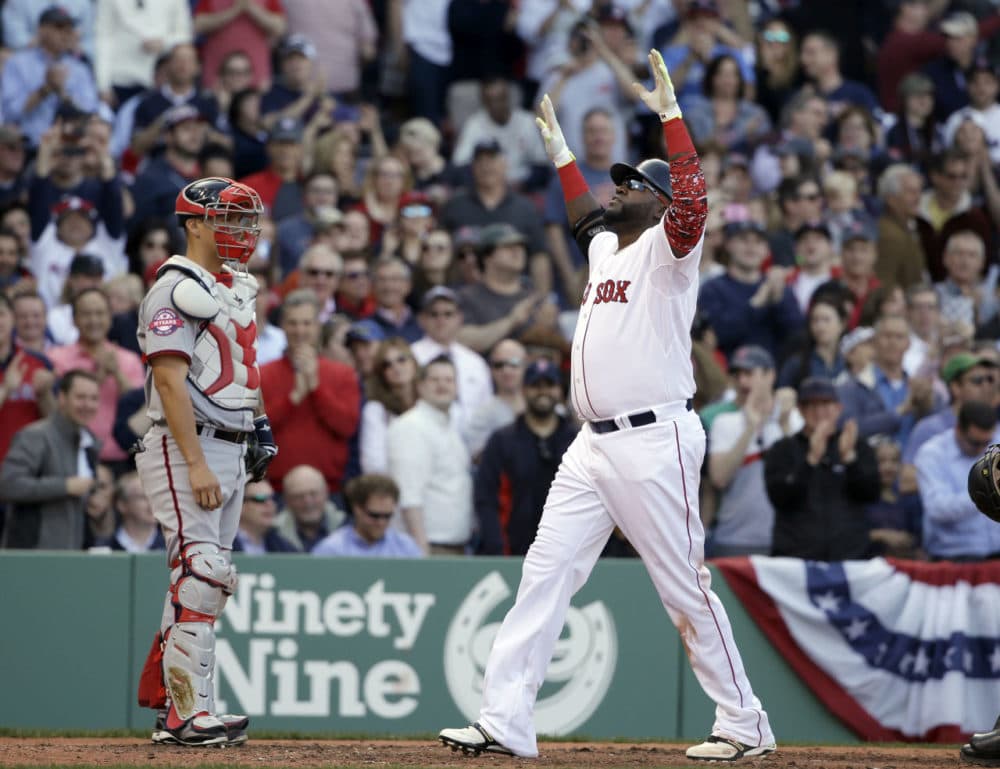 Boston Red Sox's David Ortiz, right, celebrates at home plate after hitting a home run as Washington Nationals catcher Jose Lobaton, left, watches during the sixth inning of a baseball game, Monday in Boston. The Red Sox won 9-4. (Steven Senne/AP)