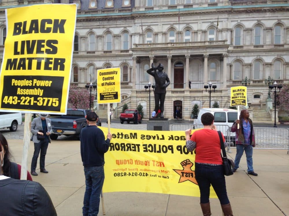 Demonstrators protest the death of Freddie Gray outside Baltimore City Hall on Monday, April 20, 2015. Gray died Sunday, a week after he was rushed to the hospital with spinal injuries following an encounter with four Baltimore police officers. (David Dishneau/AP)