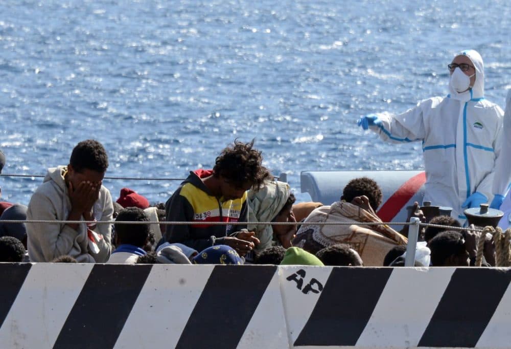 Migrants arrive in the port of Messina after a rescue operation at sea on April 18, 2015 in Sicily. A surge of migrants pouring into Europe from across the Mediterranean won't end before chaos in Libya is controlled, Italy's prime minister said yesterday, as the Vatican condemned a deadly clash between Muslim and Christian refugees on one boat. Italian authorities have rescued more than 11,000 migrants making the often deadly voyage from North Africa in the past six days, with hundreds more expected, the coastguard said. (Giovanni Isolino/AFP/Getty Images)