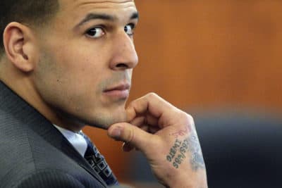 In this April file photo, former New England Patriots NFL football player Aaron Hernandez listens as prosecution witness Alexander Bradley testifies during his murder trial. (Brian Snyder/AP, Pool)