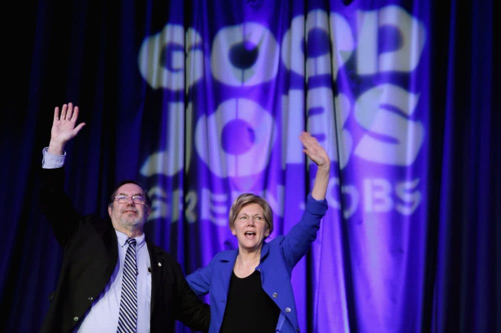 Sen. Elizabeth Warren (D-MA) is welcomed to the stage by United Steel Workers International President Leo Gerard (L) during the Good Jobs Green Jobs National Conference at the Washington Hilton April 13, 2015 in Washington, DC. Sponsored by a varied coalition including lightweight metals producer Alcoa, the United Steelworks union, the Sierra Club and various other labor, industry and telecommunications leaders, the conference promotes the use of efficient and renewable energy and cooperation in updating the country's energy infrastructure. (Chip Somodevilla/Getty Images)