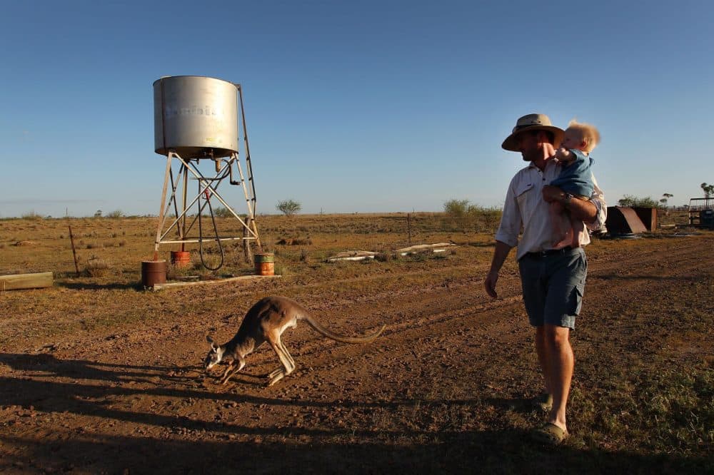 Nic Walker carries his son Tasman in his arms during a daily afternoon walk at his property 'Rio Station' on March 20, 2014 in Longreach, Australia. Queensland, Australia's second-largest state, is currently suffering from its widest spread drought on record. Almost 80 percent of the region is now declared affected. The Australian government recently approved an emergency drought relief package of A$320m, of which at least A$280m is allocated for loans to assist eligible farm businesses to recover. (Lisa Maree Williams/Getty Images)