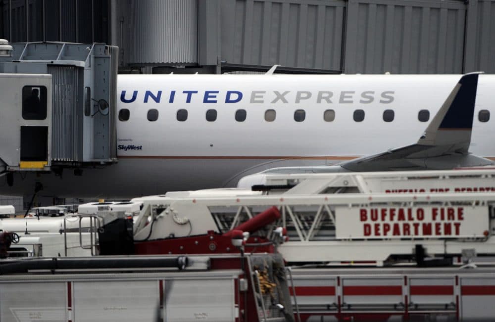 Emergency vehicles surround a SkyWest Airlines plane, operating as United Express, that made an emergency landing at Buffalo Niagara International Airport, Wednesday, April 22, 2015, in Cheektowaga, N.Y. A SkyWest spokeswoman said one passenger aboard Flight 5622, lost consciousness and the pilots rapidly descended &quot;out of an abundance of caution.&quot; (Gary Wiepert/AP)