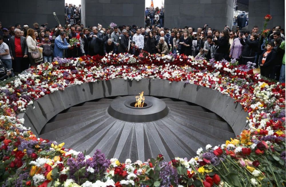 People lay flowers at a memorial to Armenians killed by the Ottoman Turks. Friday marks the centenary of what historians estimate to be the slaughter of up to 1.5 million Armenians by Ottoman Turks. (Sergei Grits/AP)