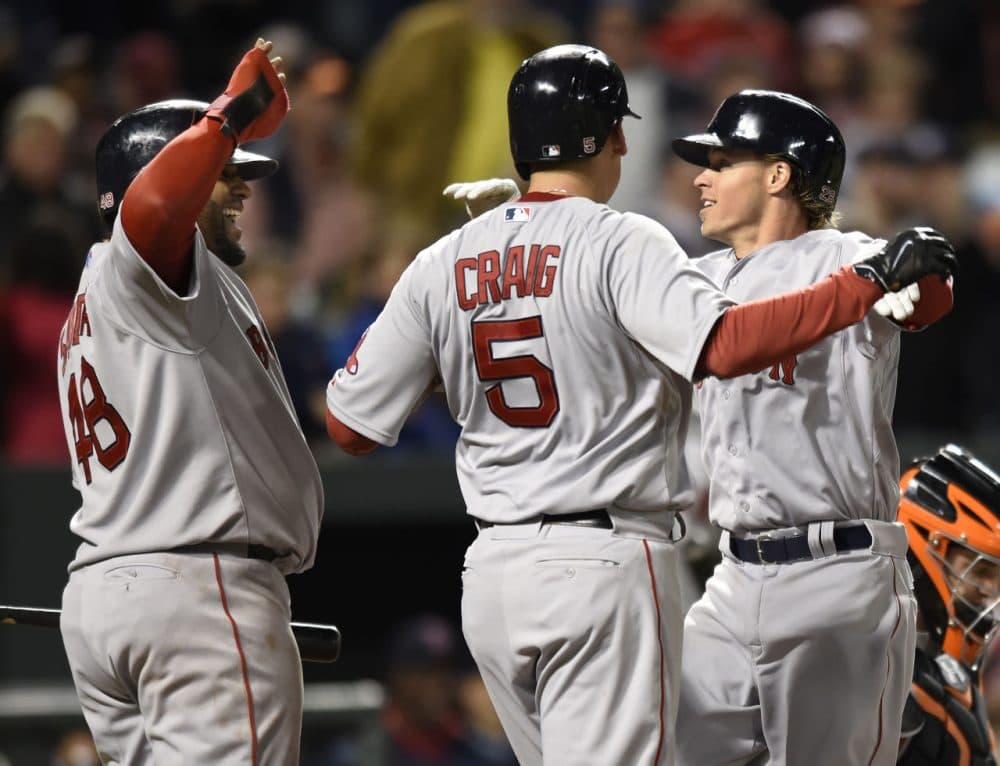 Red Sox's Brock Holt, right, celebrates his three run home run with Allen Craig, center, and Pablo Sandoval in the eighth inning against the Orioles, Friday, April 24, 2015, in Baltimore.  (AP Photo/Gail Burton)