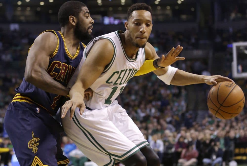 Cleveland Cavaliers guard Kyrie Irving, left, puts pressure on Boston Celtics guard Evan Turner, right, in the first quarter of a first-round NBA playoff basketball game in Sunday, April 26, 2015. (Steven Senne/AP)