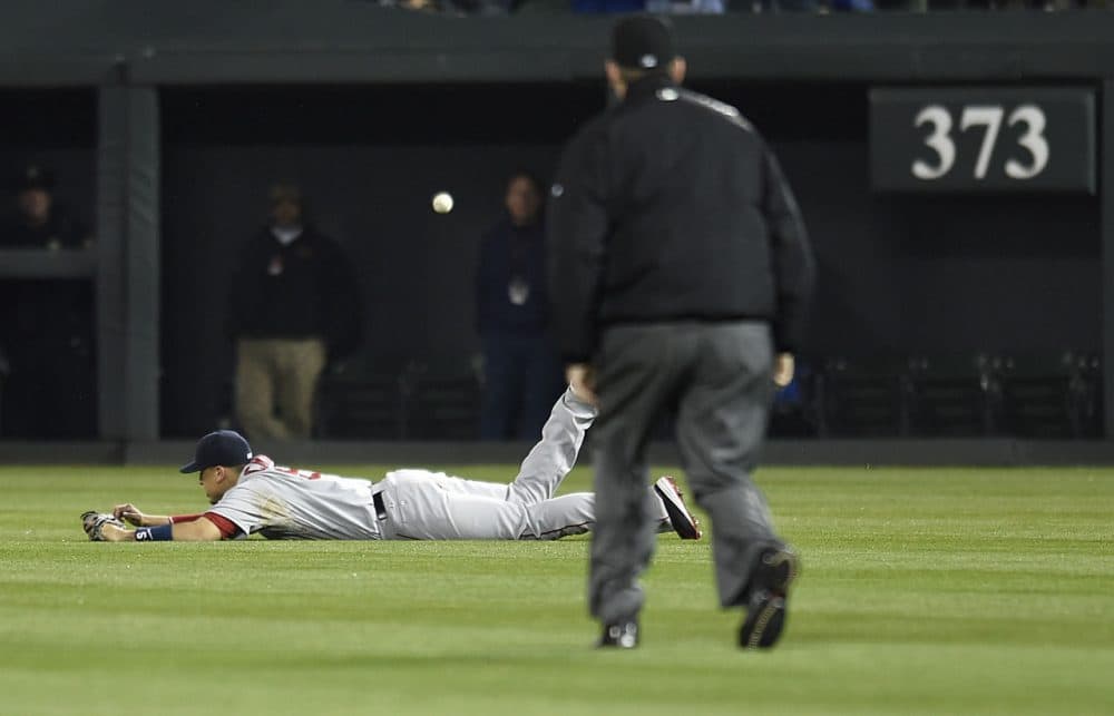 Boston Red Sox right fielder Allen Craig dives for but misses a ball hit by Baltimore Orioles Adam Jones in the 10th inning Saturday night in Baltimore. (Gail Burton/AP)