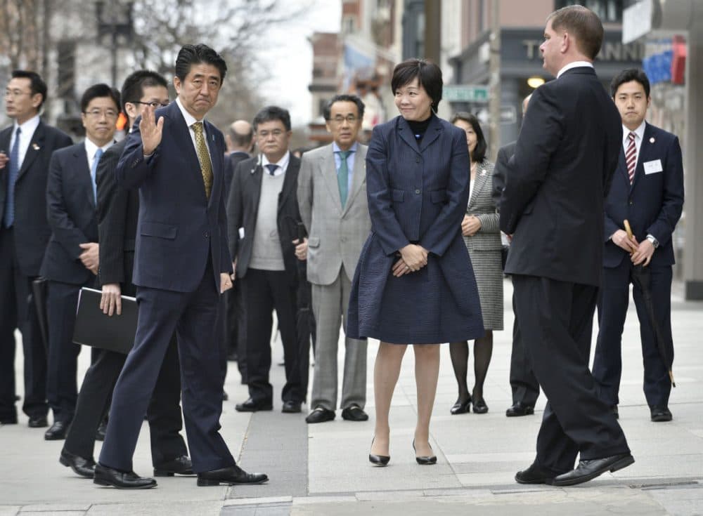 Japanese Prime Minister Shinzo Abe, center left, waves, as he and wife Akie, center, greet Boston Mayor Martin Walsh, second from right, after placing a wreath at the site of one of the 2013 marathon bombings Monday in Boston. On Wednesday, he will become the first Japanese leader to address a joint session of Congress. (Josh Reynolds/AP)
