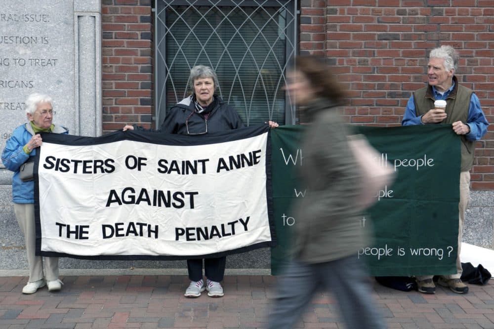 Death penalty protesters stand outside federal court Monday during the penalty phase of the federal trial of Dzhokhar Tsarnaev. (Justin Saglio/AP)