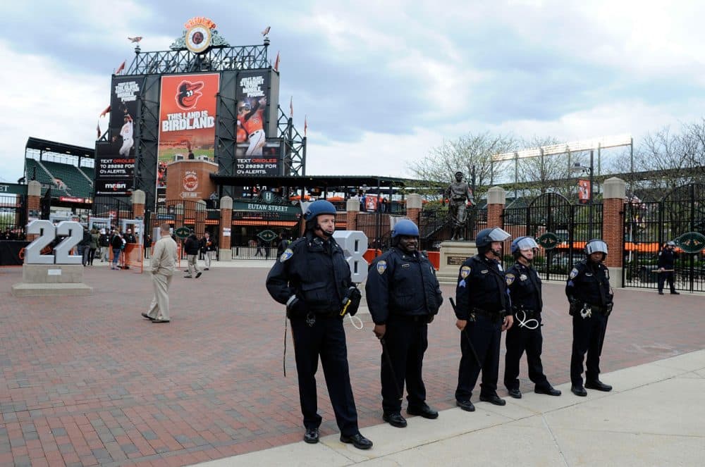 Police stand watch outside Oriole Park at Camden Yards before the game was postponed between the Baltimore Orioles and the Chicago White Sox on April 27, 2015 in Baltimore, Maryland. The move comes amid violent clashes between police and youths, according to news reports, the aftermath of the death of Freddie Gray on April 19 after suffering a fatal spinal injury while in police custody. (Greg Fiume/Getty Images)
