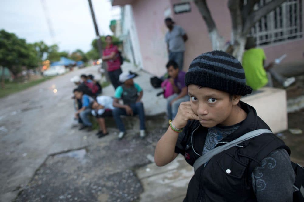 In this June 19, 2014 photo, a 14-year-old Guatemalan girl traveling alone waits for a northbound freight train along with other Central American migrants, in Arriaga, Chiapas state, Mexico. The United States has seen a dramatic increase in the number of Central American migrants crossing into its territory, particularly children traveling without any adult guardian. More than 52,000 unaccompanied children have been apprehended since October. (Rebecca Blackwell/AP)