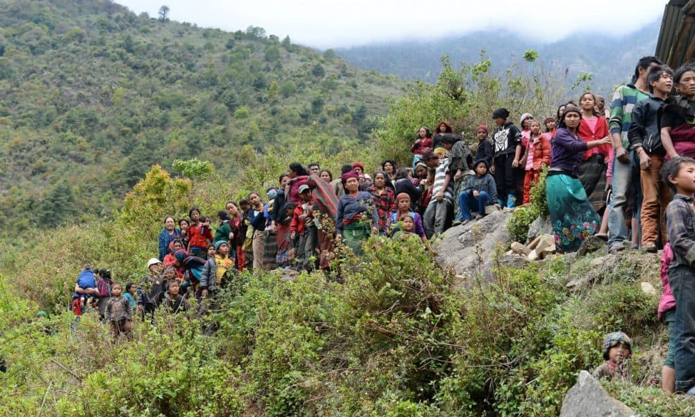Nepalese villagers wait for relief aid from an Indian Army helicopter at Uiya village, in northern-central Gorkha district on April 29, 2015. Hungry and desperate villagers rushed towards relief helicopters in remote areas of Nepal, begging to be airlifted to safety, four days after an earthquake killed more than 5,000 people. (Saijad Hussain/AFP/Getty Images)