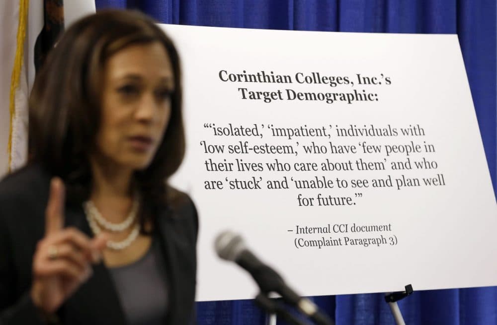 California Attorney General Kamala Harris gestures while standing by a display showing an internal document showing the target demographic of Corinthian Colleges in 2013. Harris sued the college company, alleging it misrepresented job placement rates to lure low-income state residents. Corinthian is closing its 28 remaining campuses, displacing about 16,000 students. (Eric Risberg/AP)