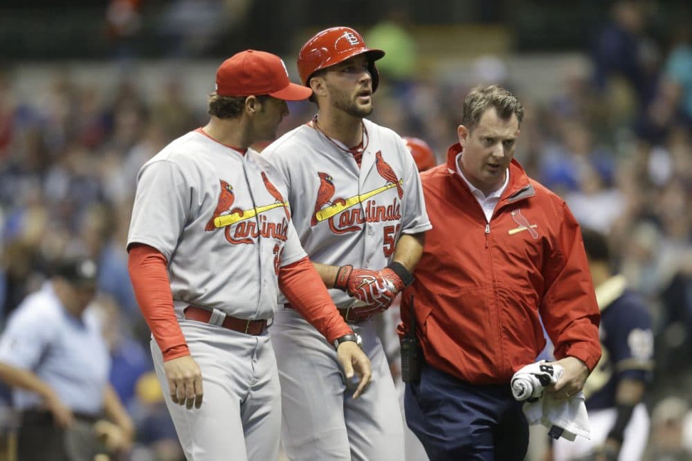 Adam Wainwright (center) sustained a season-ending Achilles injury during an at-bat against the Milwaukee Brewers. (Mike McGinnis/Getty Images)