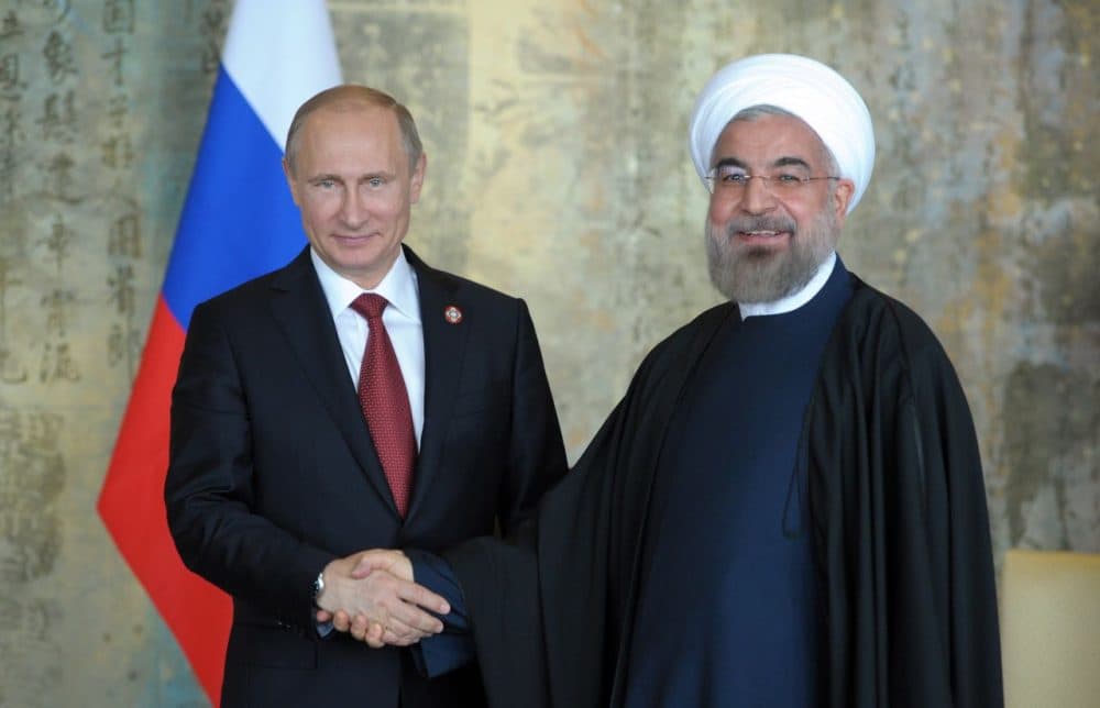 Russia's President Vladimir Putin (L) shakes with his Iran's counterpart Hassan Rouhani during their bilateral meeting on the sidelines of the fourth Conference on Interaction and Confidence Building Measures in Asia (CICA) summit in Shanghai on May 21, 2014. (Alexey Druzhini/AFP/Getty Images)