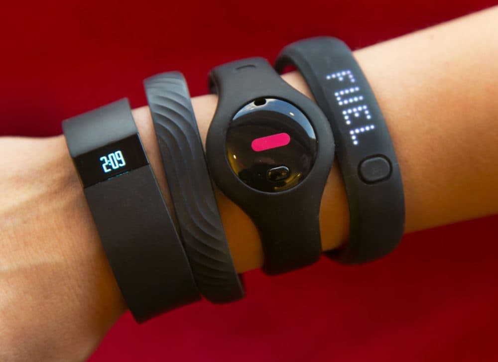 John Hancock Financial is the first U.S. insurer to offer discounts to policyholders who wear Internet-connected fitness trackers, like the ones pictured here. (Richard Drew/AP)