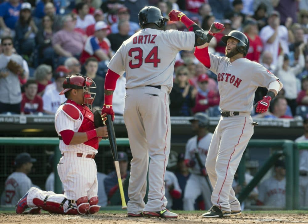 Dustin Pedroia celebrates his home run with David Ortiz during the season opener against the Phillies Monday in Philadelphia. (Chris Szagola/AP)