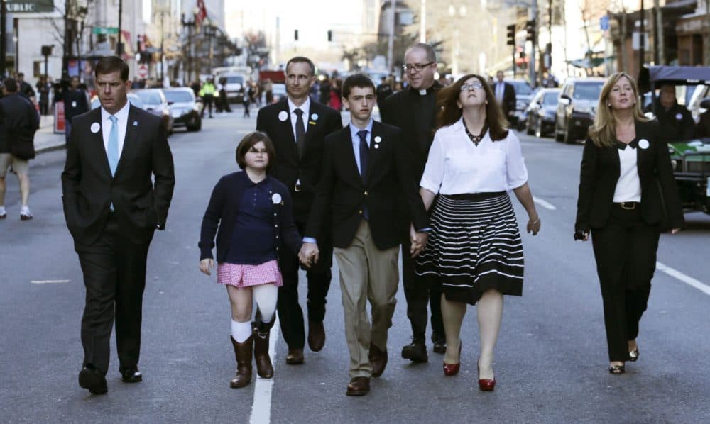 The family of Martin Richard, the youngest bombing victim, walks down Boylston Street with Boston Mayor Marty Walsh after a ceremony on Boylston Street Wednesday morning. (Charles Krupa/AP)