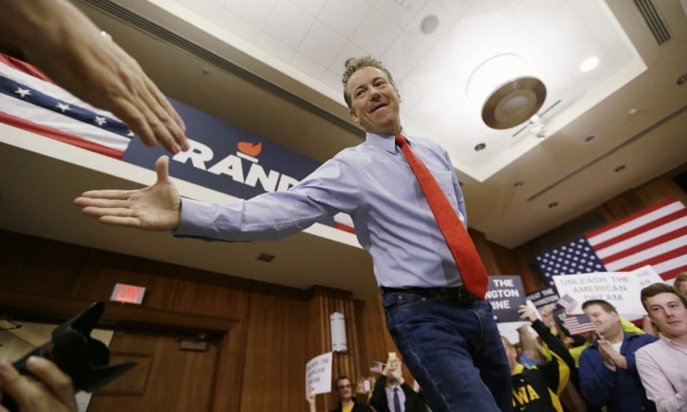 Republican presidential candidate Sen. Rand Paul, of Kentucky, greets a supporter during a rally in Iowa Friday. (Charlie Neibergall/AP)