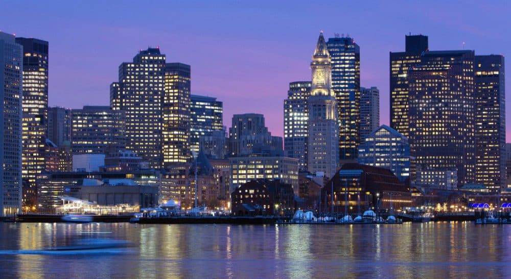 Olympic city? Boston's skyline is illuminated at dusk as it reflects off the waters of Boston Harbor. Ahead of a 2017 vote by the International Olympic Committee to select a host city for the 2024 Summer Games, Massachusetts voters will have the chance to make their voices heard in an important vote about paying for the Olympics. Former gubernatorial candidate Evan Falchuk offers a primer to what that vote would mean, why it's different from a referendum, and why voters should care. (Michael Dwyer/AP)