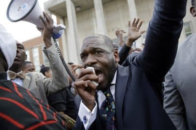 The Rev. Jamal Bryant leads a rally outside of the Baltimore Police Department's Western District police station during a march and vigil for Freddie Gray, Tuesday, April 21, 2015, in Baltimore. (AP)