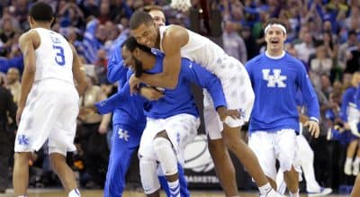 Kentucky players celebrate after a 68-66 win over Notre Dame in a college basketball game in the NCAA men's tournament regional finals, Saturday, March 28, 2015, in Cleveland. (David Richard/AP)
