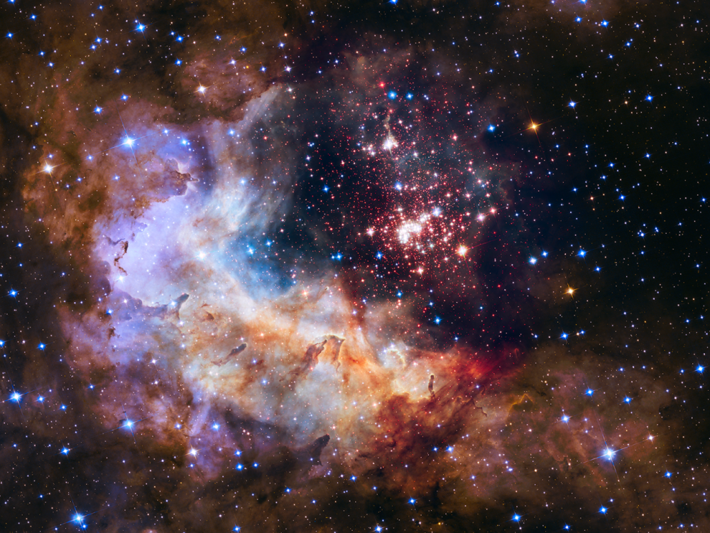 The sparkling centerpiece of Hubble’s silver anniversary fireworks is a giant cluster of about 3,000 stars called Westerlund 2. Credits: NASA, ESA, the Hubble Heritage Team (STScI/AURA), A. Nota (ESA/STScI), and the Westerlund 2 Science Team