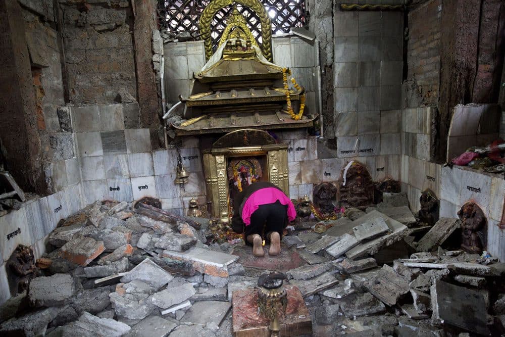 A Hindu Nepalese woman offers prayers at Indrayani temple, that was damaged in Saturday’s earthquake, in Kathmandu, Nepal, Monday, April 27, 2015. (AP)