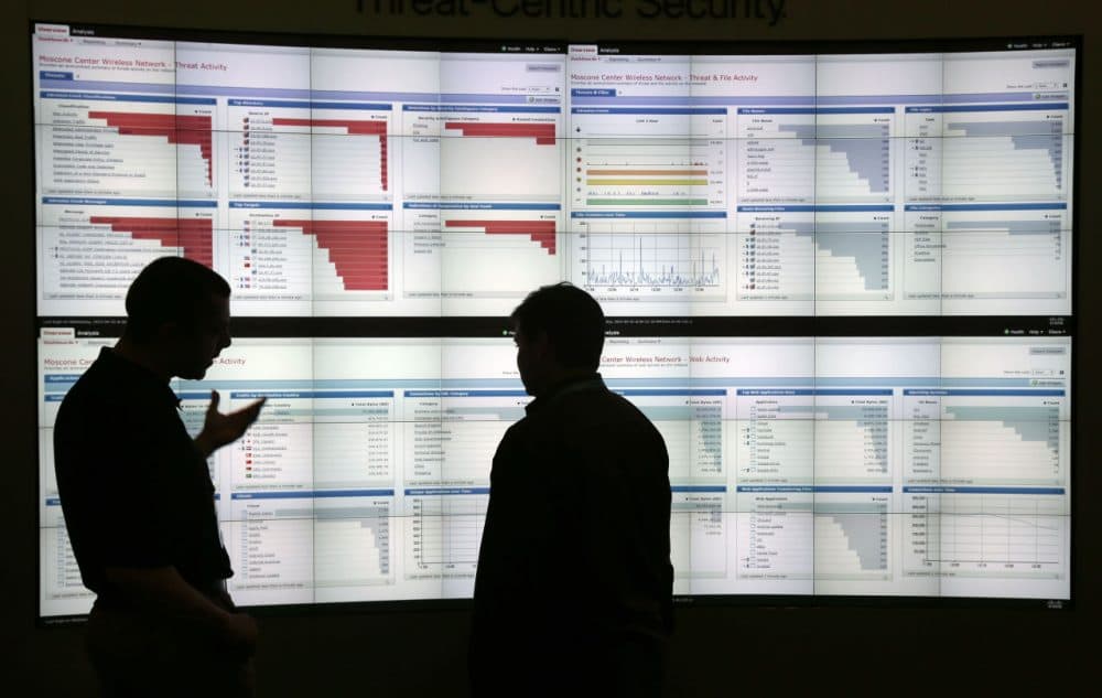Two men discuss graphics with live wireless traffic during the RSA Conference on April 22 in San Francisco. (Marcio Jose Sanchez/AP)