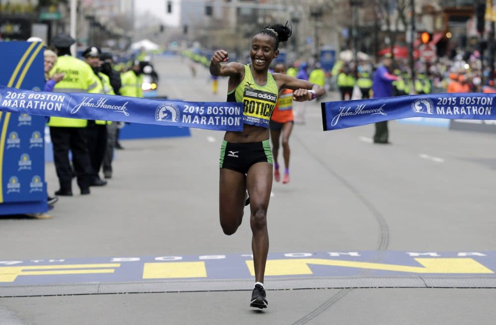 Caroline Rotich, of Kenya, breaks the tape to win the women's division of the Boston Marathon. (Elise Amendola/AP)