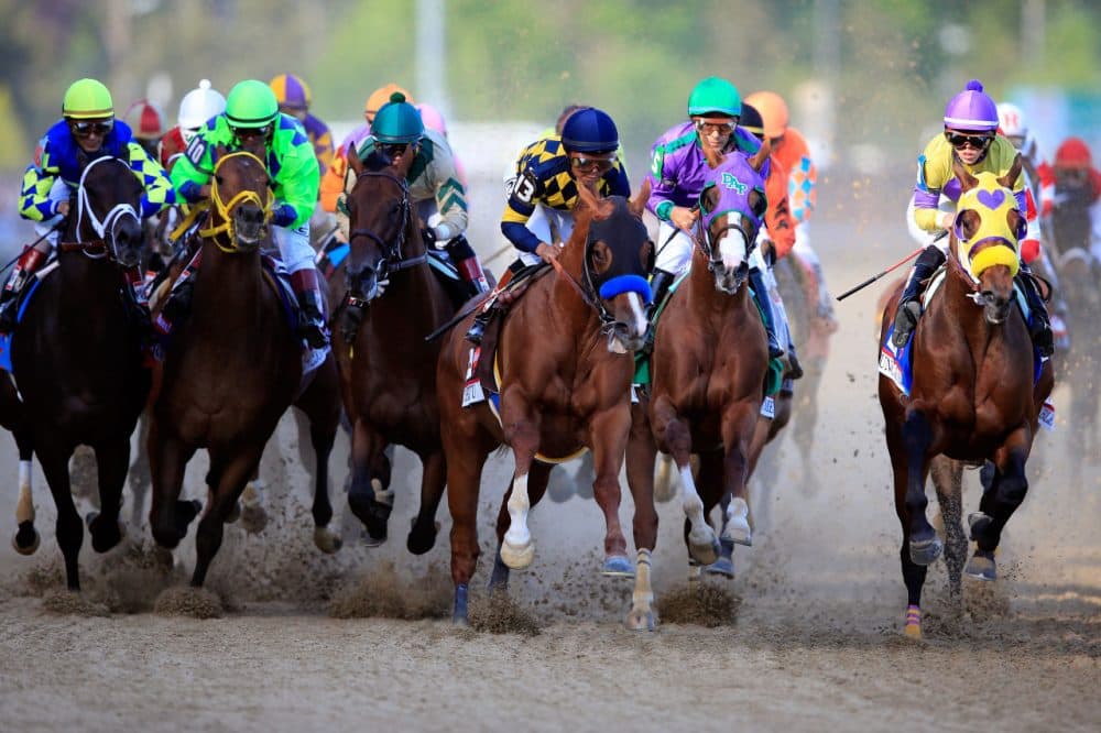 Jockey Victor Espinoza guides California Chrome #5 to the finish line to win the 140th running of the Kentucky Derby at Churchill Downs on May 3, 2014 in Louisville, Kentucky. (Rob Carr/Getty Images)