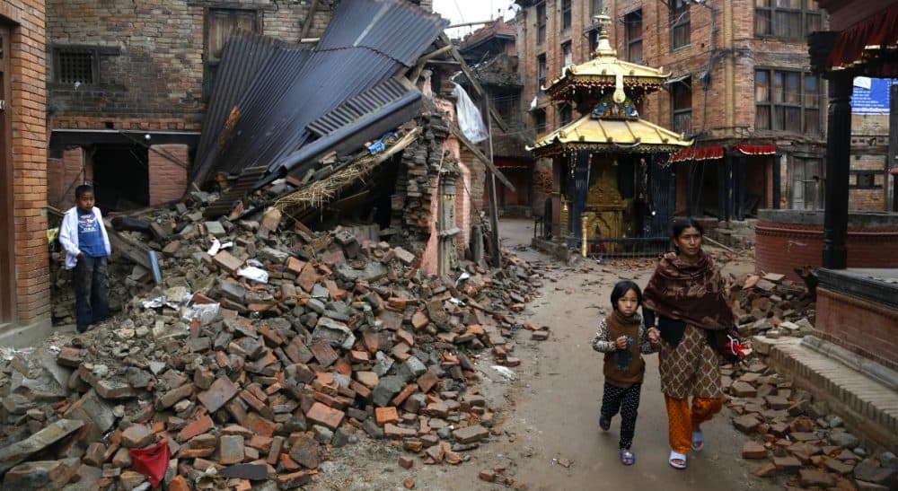 What lies beneath the rubble in Kathmandu? Memories and monuments. The first can be reconstructed, says Jessica Lipnack, the second, largely, cannot. In this Thursday, April 30, 2015 photo, a Nepalese woman and a child walk near rubble of a collapsed building in Kathmandu, Nepal. (Manish Swarup/AP)