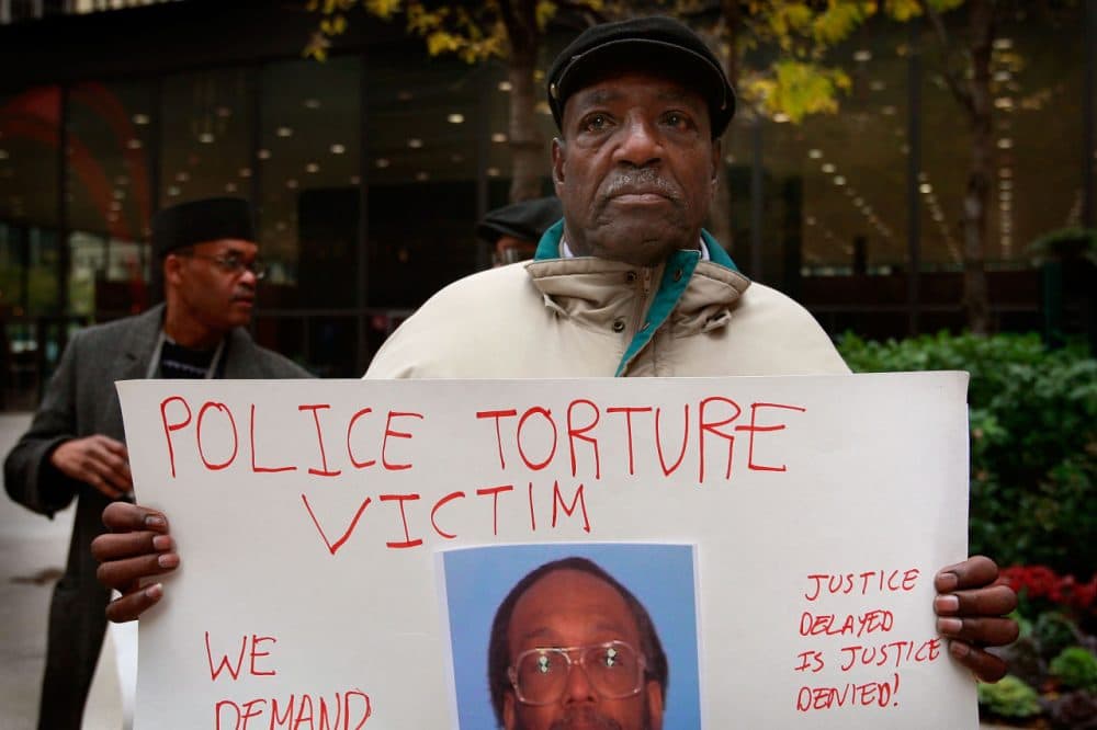 Aaron Cheney demonstrates outside the federal courthouse where former Chicago Police Commander Jon Burge was attending a hearing on charges he obstructed justice and committed perjury for lying while under oath during a 2003 civil trial about decades-old Chicago police torture allegations October 27, 2008 in Chicago, Illinois. Burge could not be charged for the torture of suspects because the federal statute of limitations for the crime had expired. (Scott Olson/Getty Images)