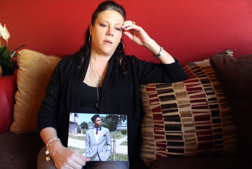 Andrea Irwin holds a photo of her son Tony Robinson, on April 1, 2015 in Madison, Wis. Irwin, whose biracial son died at the hands of a white Madison Wisconsin police officer in March, says she trusts prosecutors will get to the truth of what really happened. (Carrie Antlfinger/AP)