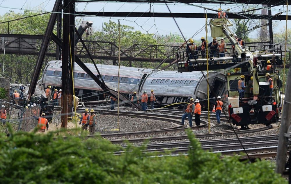 Rescuers work around derailed carriages of an Amtrak train in Philadelphia, Pennsylvania, on May 13, 2015. Rescuers on May 13 combed through the mangled wreckage of a derailed train in Philadelphia after an accident that left at least six dead, as the difficult search for possible survivors continued. (Jewel Samad/AFP/Getty Images)