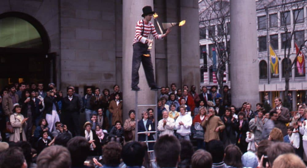 The managers of Faneuil Hall Marketplace are demanding that artists there pay between $500 and $2,500 for the privilege of earning tips and vending small wares. In this 1988 archive photo, a juggler performs at Faneuil Hall Marketplace. (Peter H. Dreyer/City of Boston Archives)