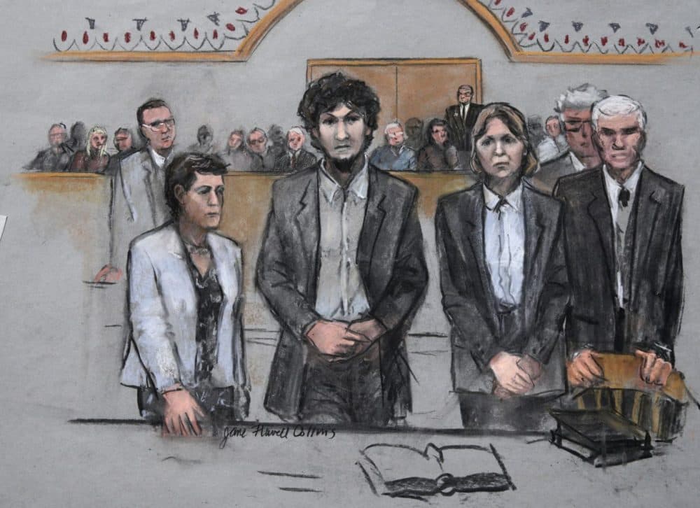 In this courtroom sketch, Dzhokhar Tsarnaev stands with his defense attorneys as a death sentence is read at the Moakley federal courthouse in the penalty phase of his trial in Boston. (Jane Flavell Collins/AP)