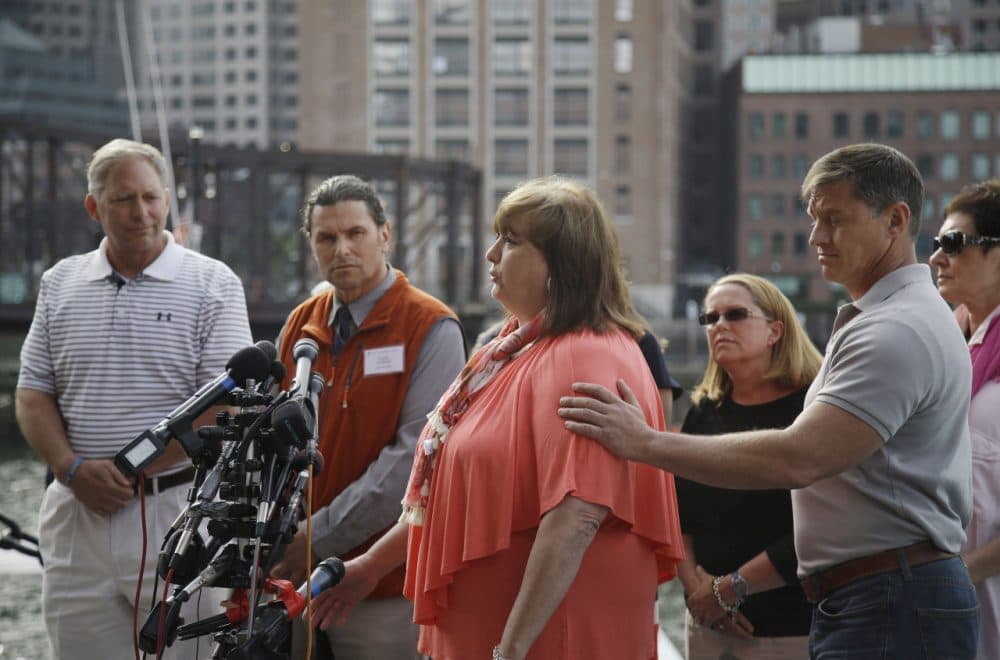 Liz Norden, whose two sons each lost a leg in the attack, speaks to media outside the courthouse and receives support from first responder Mike Ward. (Stephan Savoia/AP)